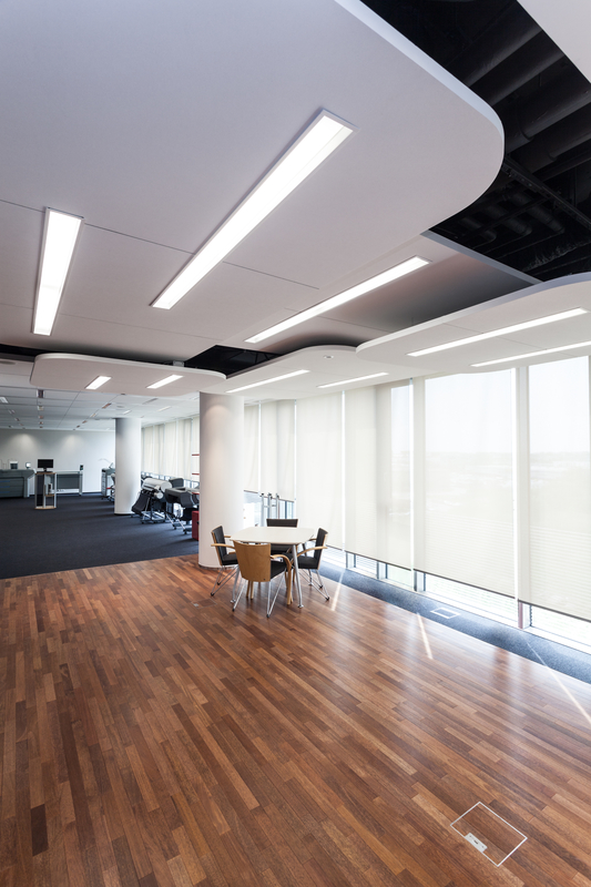 Modern office with design lighting and wooden floor.